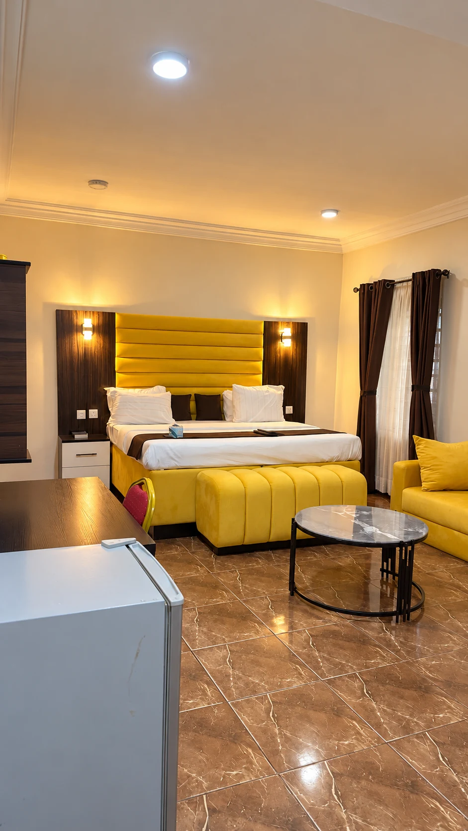 Executive Room in Nsukka with yellow bed and lounge seating