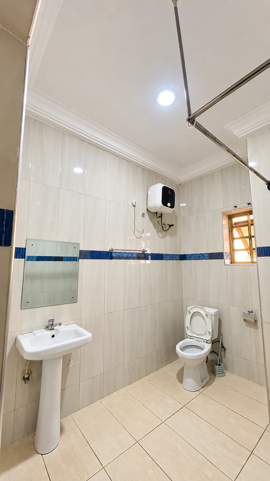 Standard Room white tiled en-suite bathroom