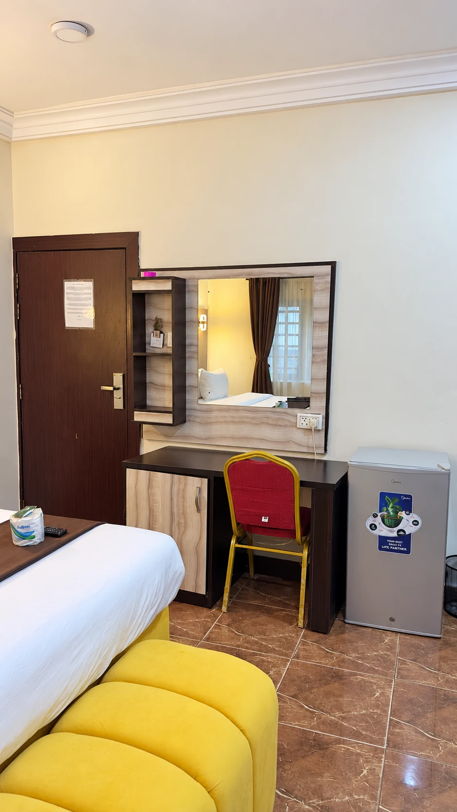 Standard Room desk, mirror and mini fridge area