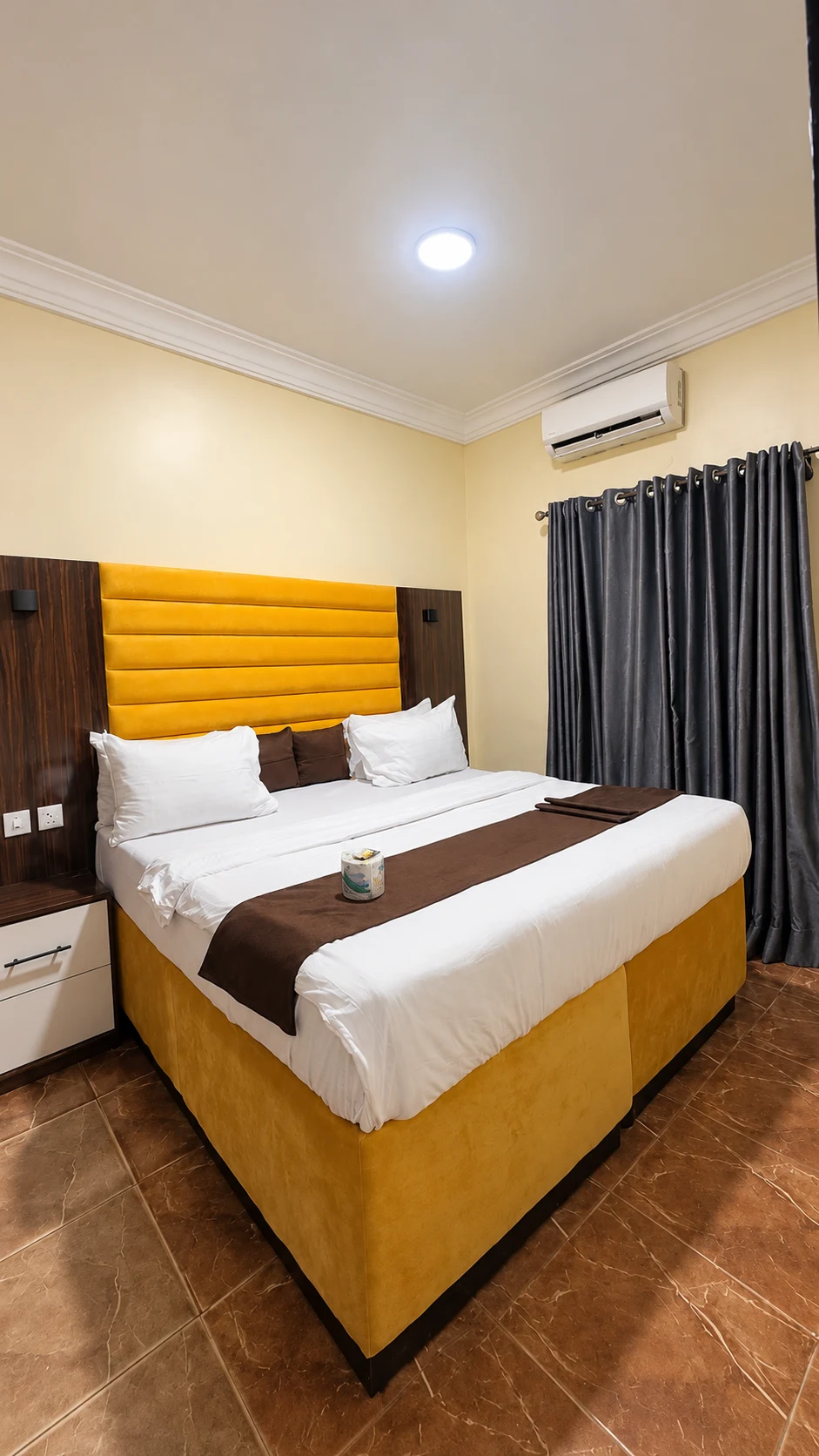 Standard Room in Nsukka with yellow upholstered bed