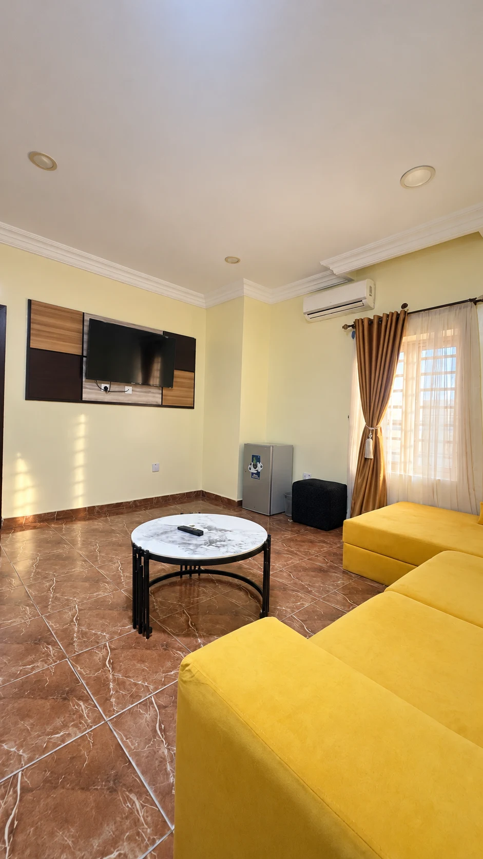 Suite Room lounge with yellow sectional seating and coffee table