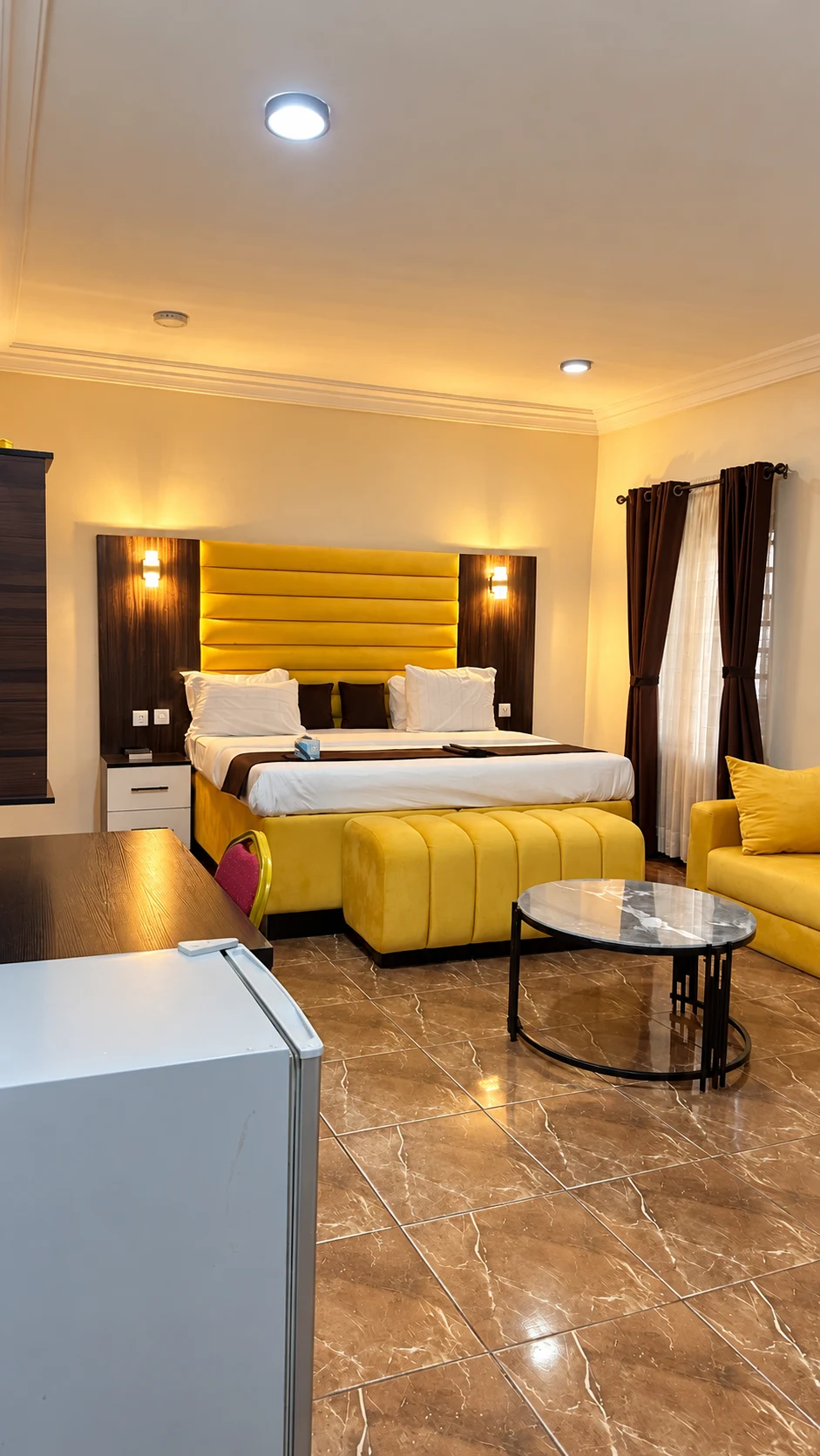 Suite in Nsukka with yellow bed and lounge seating